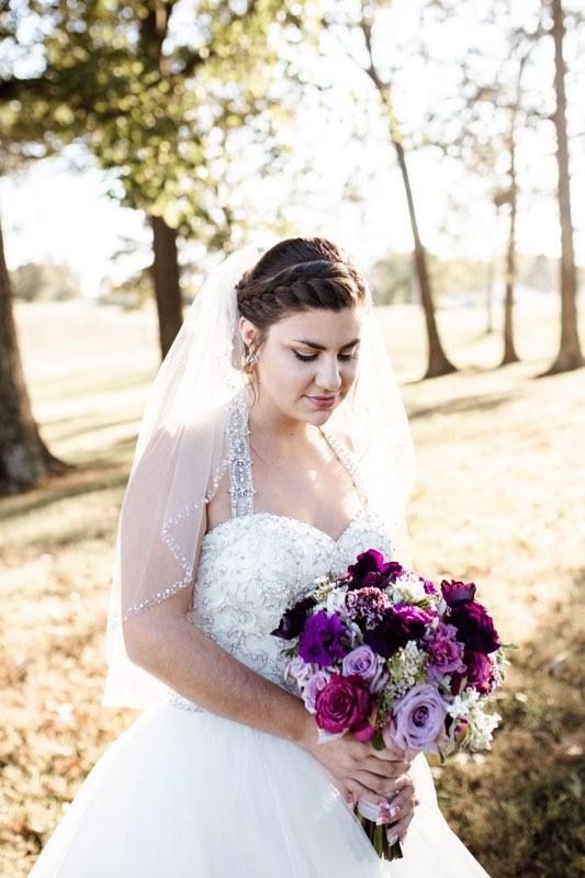 Closeup of bride with sweetheart neckline wedding dress and stunning veil.